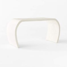 a white table with curved edges on a white background in the shape of an arch