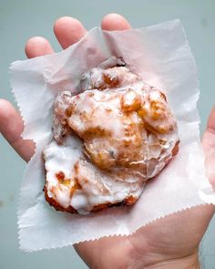 a person holding some kind of pastry in their hand