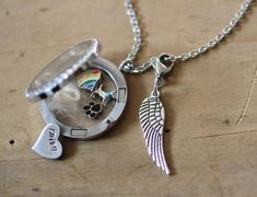 a silver necklace with an angel wing on it