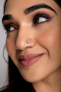 a close up of a woman with a nose piercing