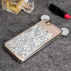 an iphone case with silver glitter on it next to lipstick and nail polish bottle in the shape of mickey mouse