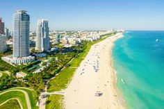 an aerial view of the beach in miami, with high rise buildings on either side