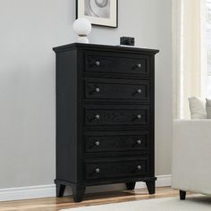 a black chest of drawers in a living room