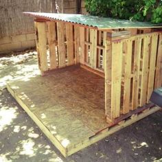 a small wooden shed sitting in the middle of a yard