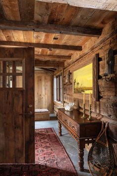 a room with wood paneling and a painting on the wall next to a door