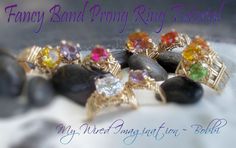 a bunch of rings that are on top of some rocks and stones with the words fancy band