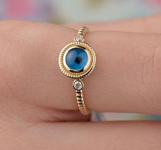 Our evil eye ring is 14k solid gold. At the top of the ring, it has a round charming evil eye between tiny zircon stones. The round evil eye on the ring, believe in that protect against to any kind of evilness in Turkey. It will be an excellent gift for your loved ones on their birthdays, mother's day, valentine's day, anniversaries, or graduations. It is a unique ring that will make happy your loved ones. We can add a gift note for your loved ones. It arrives in a special jewelry gift box. We r Yellow Gold Evil Eye Round Ring, Yellow Gold Evil Eye Ring, Yellow Gold Evil Eye Rings As Gifts, 14k Gold Evil Eye Ring, Evil Eye Promise Ring, Women Protection, Round Evil Eye, Gold Ring Unique, Ring With Stone