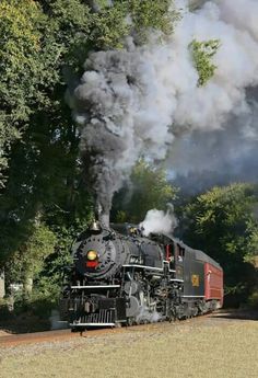 an old fashioned steam train traveling down the tracks