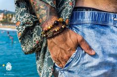 "A set of 3 wooden beaded bracelets for men with lava stones, natural seed beads from India and Malasia, Lava stones from Tenerife, and an ancient coin from Spain. The set is composed of 3 bracelets: 1. Stretchy bracelet of 18cm (adjustable length) with natural stones, seed beads, and a bronze charm. 2. Stretchy bracelet of 18 cm (adjustable length) made from dark wood beads. 3. Fixed-size bracelet of 18 cm with screw closure and an ancient Spanish coin. Comes with a gift wrap IMPORTANT: The bas Brown Gemstone Beads Bracelets For Festival, Brown Gemstone Beaded Bracelets For Festival, Festival Brown Beaded Bracelets With Gemstone, Festival Brown Gemstone Beaded Bracelets, Mens Wood Bracelet, Beaded Bracelets For Men, Beaded Bracelet For Men, Wooden Beaded Bracelets, Sliding Knot Closure