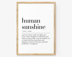 a black and white print with the words human sunshine on it in a wooden frame