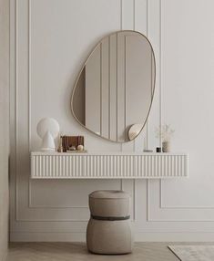 a white table with a round mirror on it