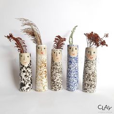 four ceramic vases with plants in them