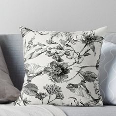 a black and white floral print pillow on a couch