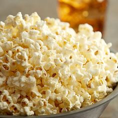 a bowl filled with popcorn sitting on top of a table