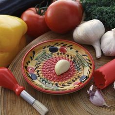 an assortment of vegetables including garlic, tomatoes and broccoli on a wooden table