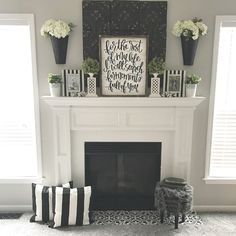 a white fireplace with black and white decor