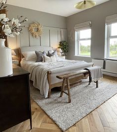 a bedroom with a large bed and wooden flooring in it's center area