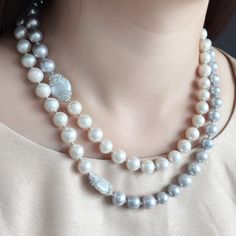 This multi-way necklace is made of white and gray freshwater pearls with rhinestones bordered pearls and white gold plated brass findings trimmed. Can wear it as a single long necklace or double wrapped short necklace. Matching with a soft and simple blouse, bare shoulder top or midi dress look so feminine and stunning. It's a timeless piece and a nice gift for a birthday, wedding party or anniversary. It will be contained in a nice jewelry case and well packed.  Be different with plastic beads Luxury Silver Pearl Embellished Necklace, Luxury Silver Pearl Chain Necklace, Luxury Beaded Pearl White Pearl Necklace, Luxury Pearl White Beaded Pearl Necklace, Luxury Pearl White Beaded Necklaces, Luxury Pearl White Beaded Necklace, Elegant Single Strand Mother Of Pearl Necklace, Luxury Silver Single Strand Pearl Necklace, Luxury Pearl White Mother Of Pearl Necklace