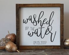 a sign that says washed by the water on it next to some christmas ornaments and other decorations