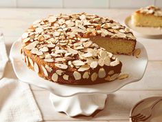 a cake with almonds is on a white plate