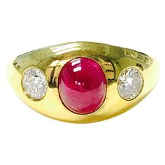 Three stone ruby and diamond ring handcrafted in 14k yellow gold. The details are as follows : oval ruby weight : 2.63 carat diamond weight : 0.56 carat Metal : 14k yellow gold Measurements : 0.40" tapered to 0.10" Oval Cabochon Ruby And Diamond Ring, Oval Cabochon Ruby Ring With Diamonds, Oval Ruby Ring With Vvs Clarity Diamond, Luxury Oval Three-stone Ruby Ring, Red Diamond Oval Cabochon Ring, Classic Three Stone Ruby Ring In Yellow Gold, Classic Three Stone Yellow Gold Ruby Ring, Classic Yellow Gold Three Stone Ruby Ring, Oval Ruby Ring With Three Diamonds