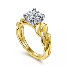 a yellow gold engagement ring with a round diamond