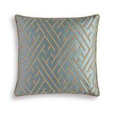 a blue and gold pillow on a white background