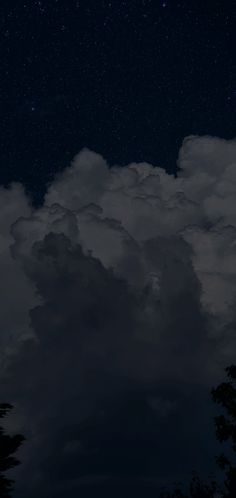 the night sky is filled with clouds and stars