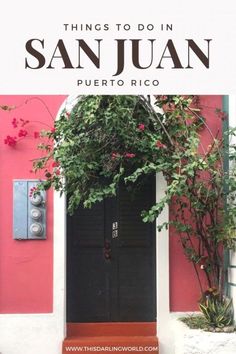 the front door to an apartment building with pink walls and green plants growing over it