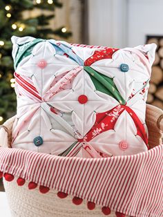 a christmas pillow in a basket on a table