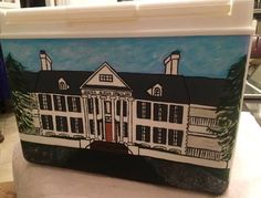 an image of a house painted on the side of a cooler