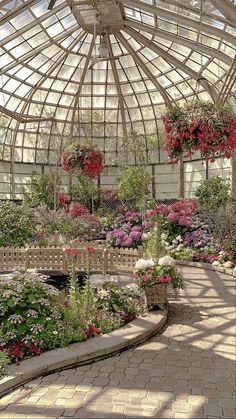 the inside of a greenhouse filled with lots of flowers