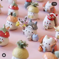 there are many small figurines that look like they have fruit on their heads