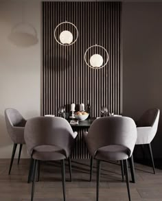 a dining room table with four chairs and two lamps on the wall next to it