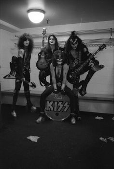 the kiss band posing for a photo in their dressing room with guitars and guitar heads