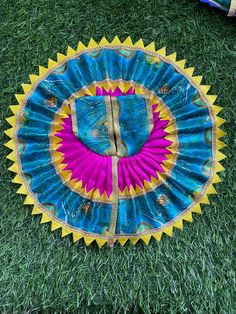 a blue and yellow frisbee laying on top of green grass