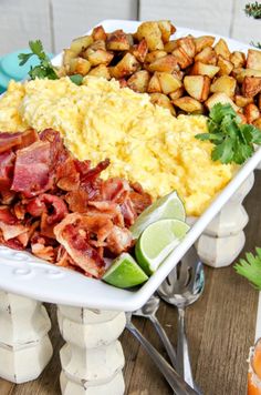 a large platter filled with different types of breakfast foods and garnished with cilantro