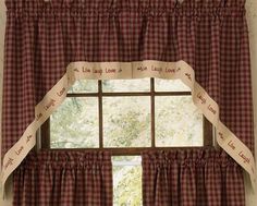 the window is decorated with red and white checkered curtains, which have words written on them