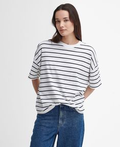 The Barbour Marnie Striped T-Shirt is a must-have style for laid-back days. This super-soft, yarn-dyed cotton t-shirt features short sleeves and dropped shoulders for a casual look, while the relaxed fit and woven logo patch the reverse ensures its made for everyday wear. Summer T-shirt With Shirttail Hem For Everyday, Relaxed Fit T-shirt With Shirttail Hem For Day Out, Trendy Striped T-shirt With Relaxed Fit, Relaxed T-shirt For Casual Summer Gatherings, Summer Shirttail Hem T-shirt For Everyday, Spring T-shirt For Casual Gatherings With Shirttail Hem, Spring Casual T-shirt With Shirttail Hem, Cotton Crew Neck Short Sleeve Top For Day Out, Relaxed Striped Summer Tops