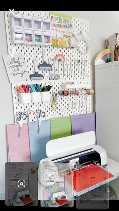 a sewing machine sitting on top of a table next to a wall mounted pegboard