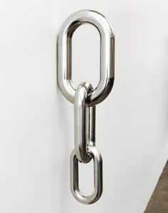 a large metal chain hanging from the side of a wall