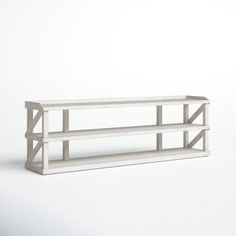 a white shelf sitting on top of a wall