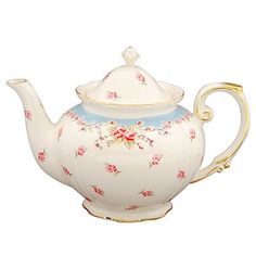 a white tea pot with pink flowers on it and a gold rim around the top