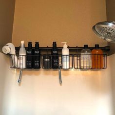 a bathroom shelf with soap, lotion and shampoos hanging from it's sides