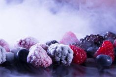 berries, raspberries, blueberries and blackberries are covered in powdered sugar