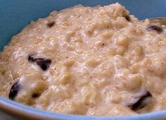 a blue bowl filled with oatmeal and raisins