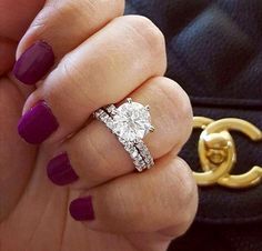 a woman's hand with two rings and a ring on top of her finger