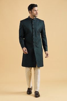 Peacock green sherwani in velvet base featuring geometric thread and sequin embroidery all over. Paired with a light chikoo color pant. - Aza Fashions Green Sherwani With Mirror Work For Eid, Green Sherwani With Mirror Work For Festive Occasions, Festive Green Sherwani With Mirror Work, Bollywood Style Green Sherwani With Mirror Work, Green Bollywood Sherwani With Mirror Work, Green Wedding Sherwani With Mirror Work, Fitted Meenakari Kurta For Festivals, Green Bandhgala For Reception And Festivals, Green Bandhgala For Eid Reception