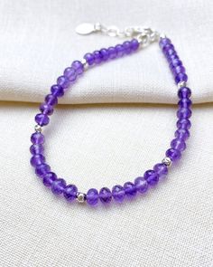 Treat her royally, with a gemstone bracelet the color of royalty. This sublime beaded bracelet features a strand of micro-faceted amethyst stones in the most rich shade of purple. Small sterling silver beads interspersed along the strand add extra brilliance to this refined design. A secure lobster clasp and extender chain allow a comfortable fit for most wrists, so you can be confident when gifting that it will fit. Amethyst is the birthstone for February Amethyst is also traditionally given for the sixth wedding anniversary Amethyst is a purple shade of quartz Bracelet length: 7.25 inches plus 1-inch extender Materials: 3.5-4 mm amethyst beads, .925 sterling silver components, multi-strand stainless steel beading wire Free USA shipping and returns. Adjustable Purple Beaded Bracelet With Faceted Beads, Adjustable Purple Beaded Bracelets With Faceted Beads, Elegant Purple Rondelle Beaded Bracelets, Faceted Purple Amethyst Beaded Bracelets, Purple Amethyst Faceted Beaded Bracelets, Adjustable Amethyst Jewelry With Polished Beads, Amethyst Gemstone Beaded Bracelets, Adjustable Amethyst Gemstone Beaded Bracelets, Purple Faceted Amethyst Beaded Bracelets