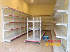 empty shelves in a store with red and white shelving